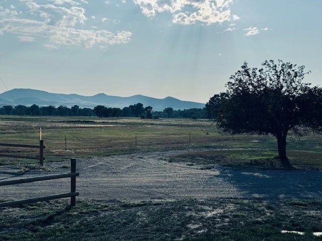 Open pasture and fence with mountain views